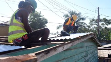 Photo of Jamaican expatriate gifts new roof to blind couple