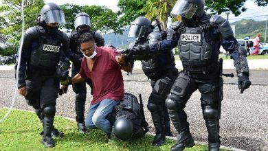 Photo of Trinidad police tear-gas vaccine protesters
