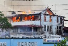 Photo of NA wooden building hit by two fires